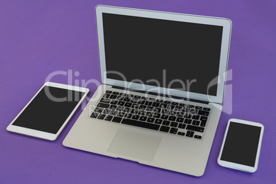 Laptop, mobile phone and digital tablet on purple background