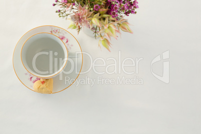 Empty cup and saucer with sweet food