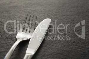 Fork and knife on black background