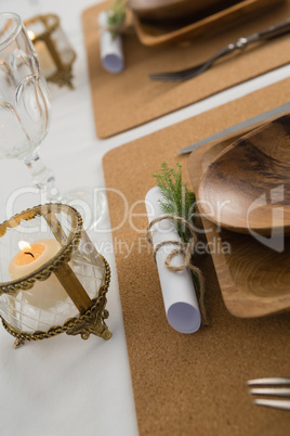 Wooden plate and cutlery set on a table