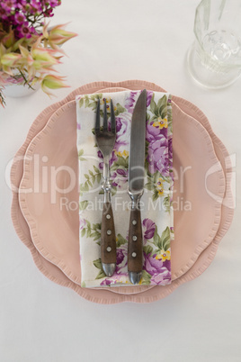 Fork, butter knife and napkin in a plate
