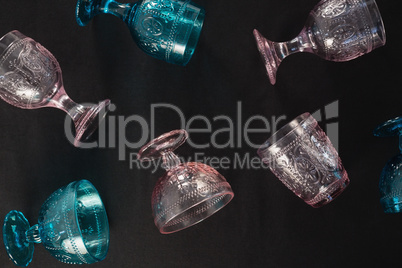 Colored glass and cups against a black background