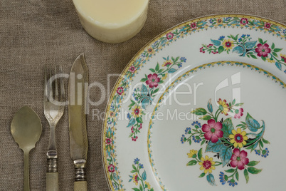 Floral pattern plate with cutlery set and candle