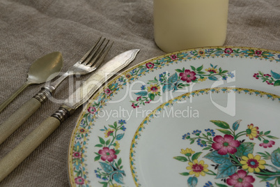 Floral pattern plate with cutlery set and candle