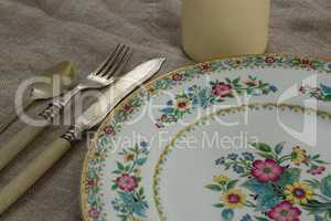 Floral pattern plate with cutlery set and candle