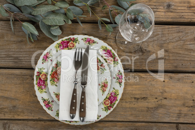 Floral pattern plate with cutlery set and wine glass