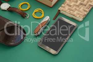 Organizer, wristwatch, pocketknife, mobile phone and sunglasses case on gr