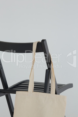 Grocery bag hanging on black chair