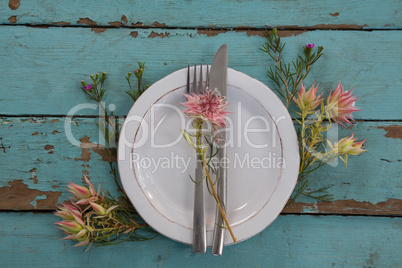 Cutlery with flower in a plate