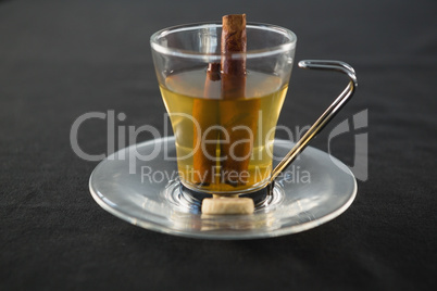 Glass cup of tea with cinnamon