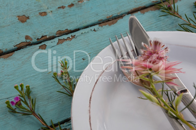 Cutlery with flower in a plate