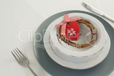 Grapevine wreath and decoration on a plate with fork and butter knife