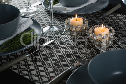 Elegance table setting with lit candle