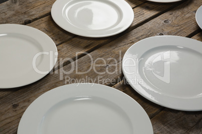 Empty plates on wooden plank