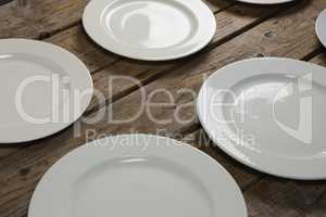 Empty plates on wooden plank