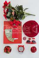 Female accessories, fruits, currency and bunch of flower on white background