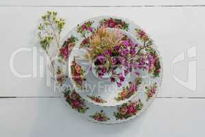 Plate and bowl with flower on white background