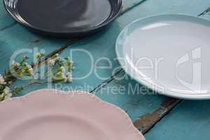 Empty plates with flower on wooden table