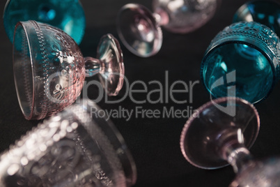 Colored glass and cups against a black background