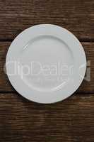 White plate on wooden table