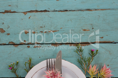 Cutlery with flower in a plate