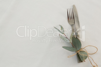 Fork and butter knife tied with leaf