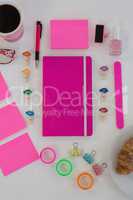 Female accessories, stationery and coffee on wooden surface