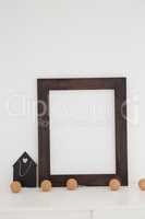 Picture frame with decorations on table