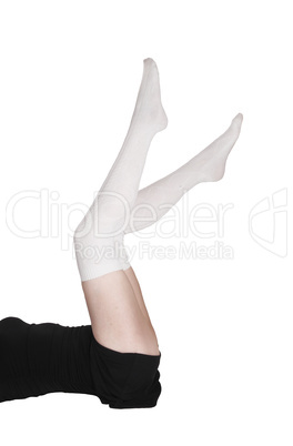 Woman lying on floor with her legs up