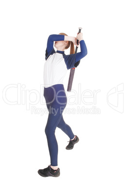 Woman swinging her bat in softball