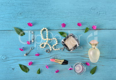 Cosmetics, perfumes and jewelry made of pearls on an old wooden