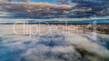 Riga city Autumn Drone flight above and sunrise above clouds