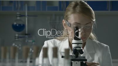 Lab technician doing microscope sample analysis