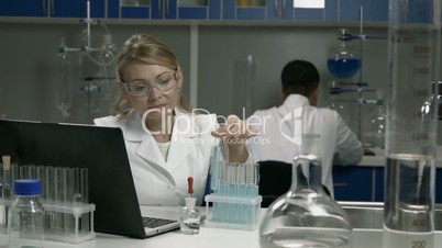 Female scientist conducting an experiment in lab