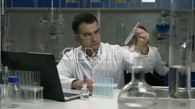 Male scientist working with tubes in laboratory