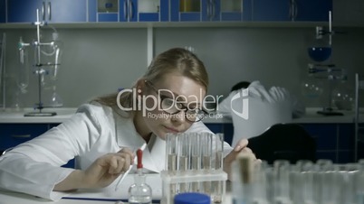 Exhausted scientists sleeping on workplace in lab