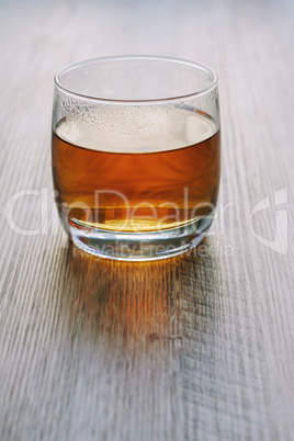 Tea in a glass on a wooden table