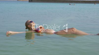 Pregnant woman and her son bathing in Dead Sea and having fun