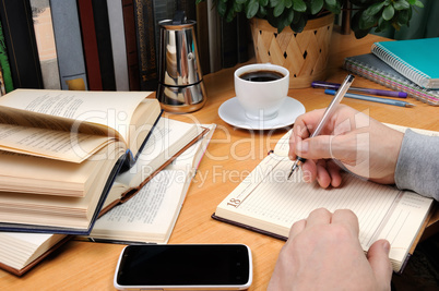A man takes notes in a notebook