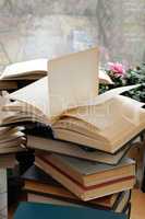 Stack of books with an open book