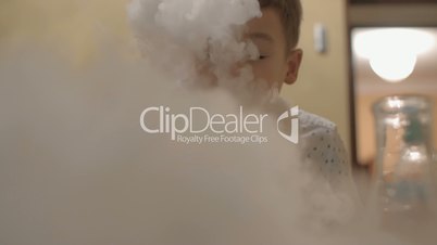 Child is happy to play with liquid nitrogen white smoke
