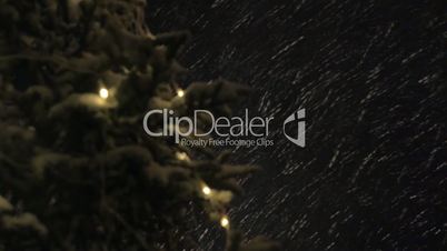 Night snowfall and Christmas tree