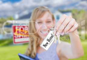 Woman Holding New House Keys with New Home Card In Front of Sold