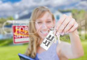 Woman Holding New House Keys with Your Home Sweet Home Card In F