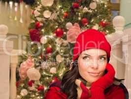 Warmly Dressed Female In Front of Decorated Christmas Tree.