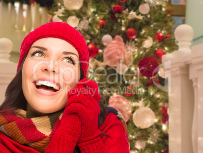 Warmly Dressed Female In Front of Decorated Christmas Tree.