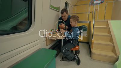 Father and child in train play space