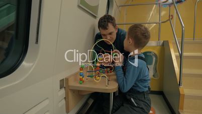 Dad and son spending time in train play room