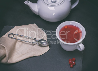 tea from berries of a viburnum in a white ceramic cup