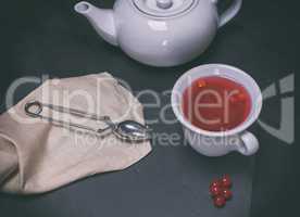 tea from berries of a viburnum in a white ceramic cup